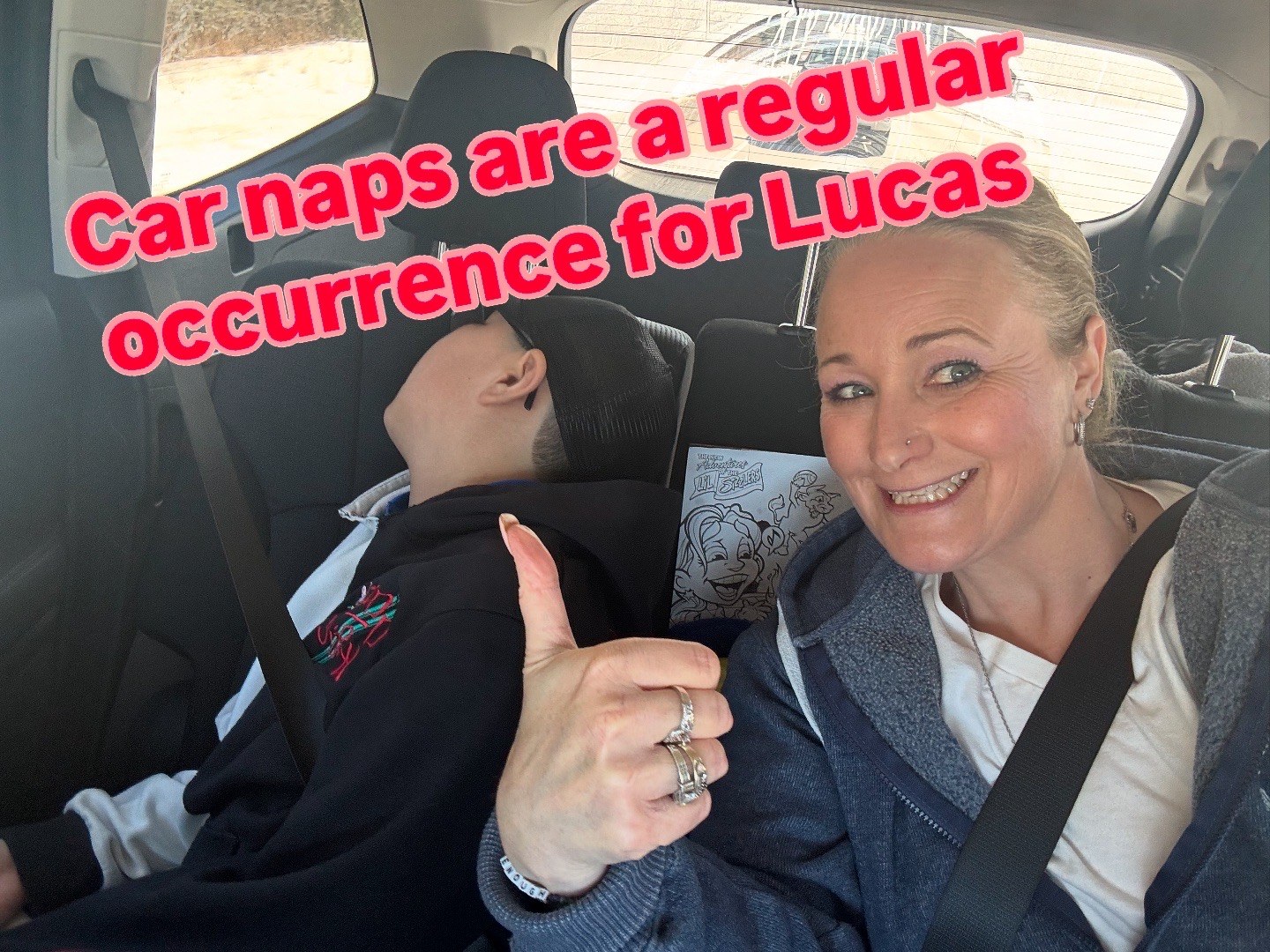 Lucas asleep during a car ride while Kathy sits nearby