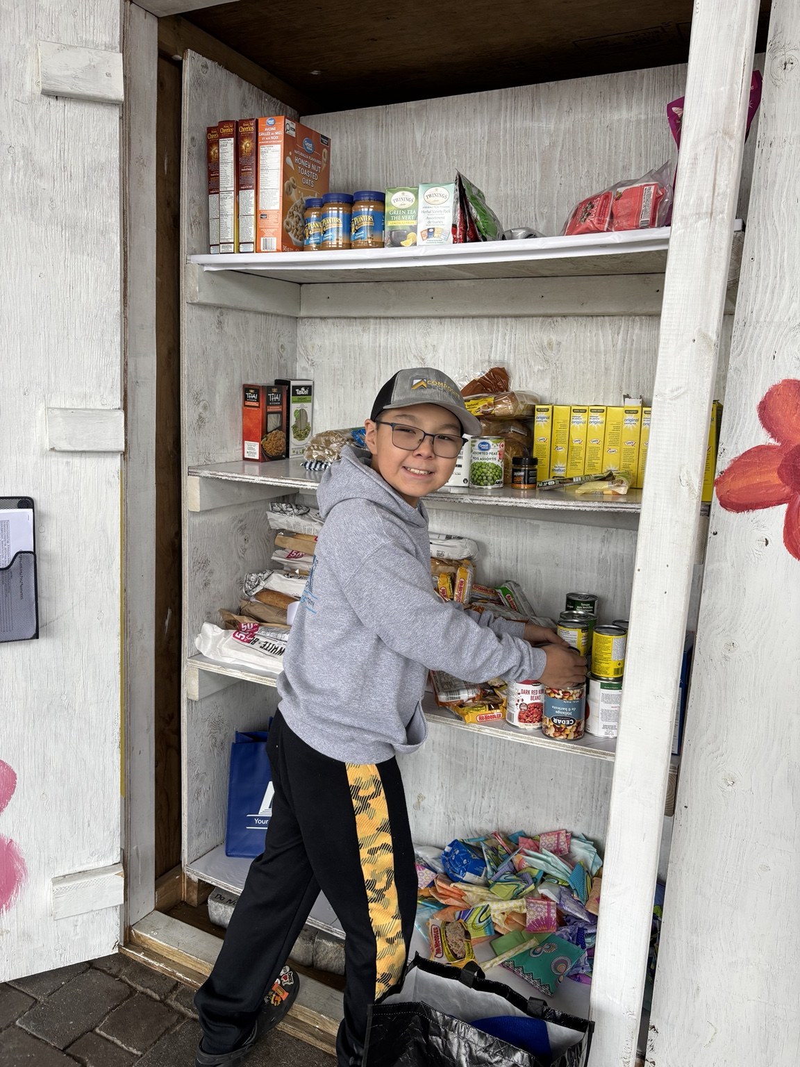 Lucas stocking a community food pantry