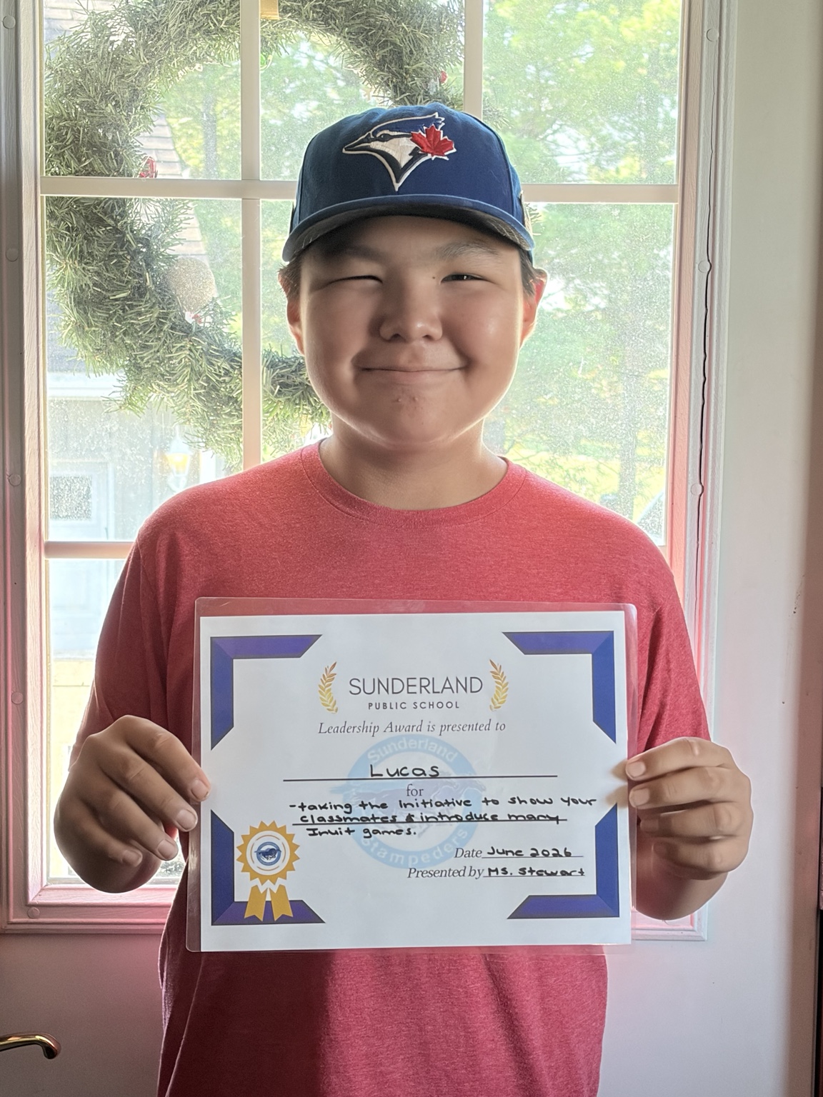 Lucas holding his school leadership award