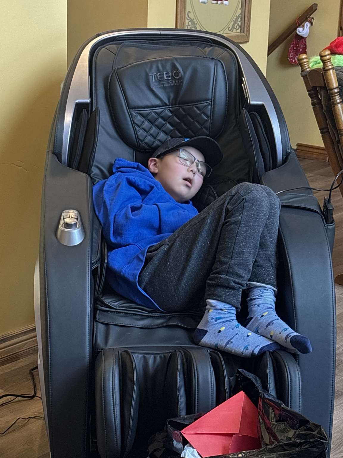 Lucas asleep in a massage chair