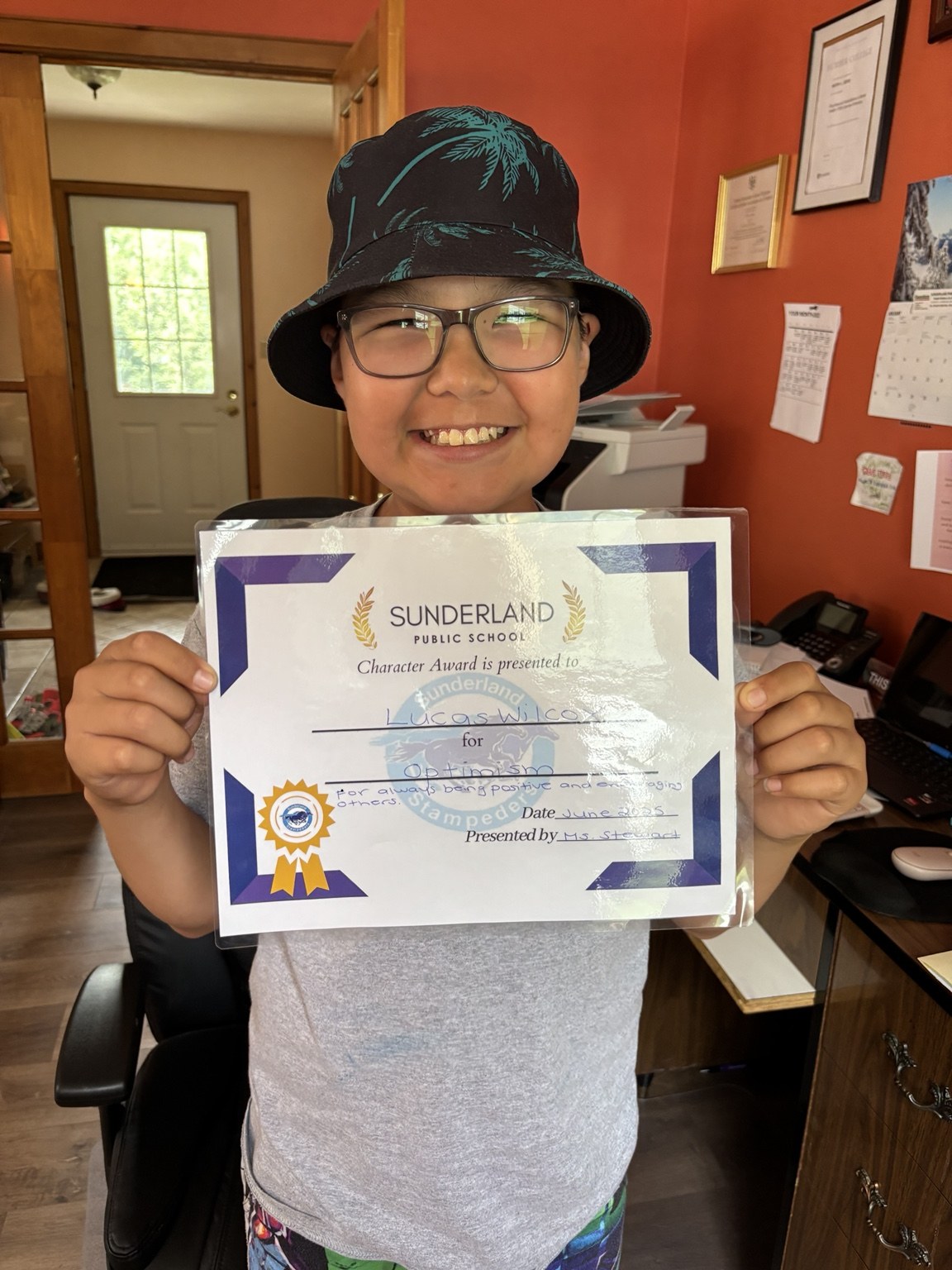 Lucas holding a school character award